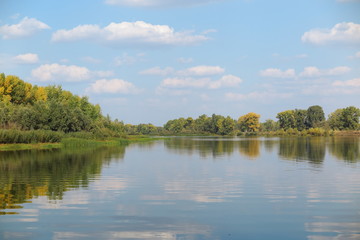 Fototapeta na wymiar September river against a blue sky