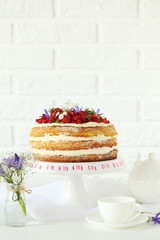 Delicious biscuit cake with berries on cake stand