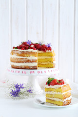 Delicious biscuit cake with berries on cake stand
