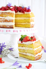 Delicious biscuit cake with berries on cake stand