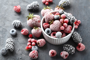 Frozen berries on a black wooden table