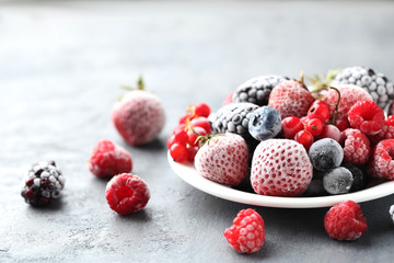 Frozen berries on a black wooden table