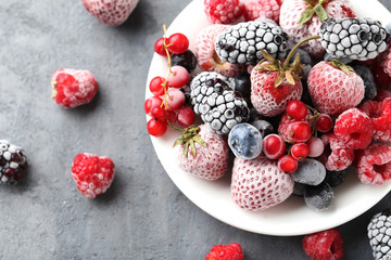 Frozen berries on a black wooden table