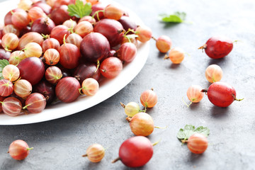 Gooseberries fruit on a grey table