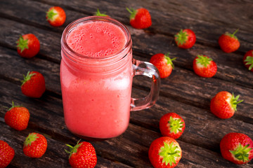 Strawberry smoothie in jar glass on wooden table. healthy food concept for breakfast or snack.