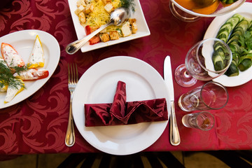 Table in a restaurant with glasses, napkins and cutlery