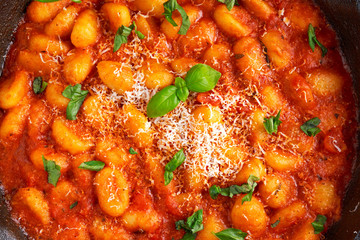 Homemade Italian Gnocchi with marinara sauce, cheese in iron pan