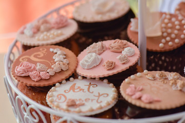 Muffins with marzipan shaped arrangement of roses