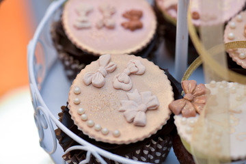 Muffins with marzipan shaped arrangement of roses top view