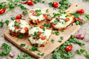 Cooked Mushrooms stuffed with cheese and plum tomatoes.