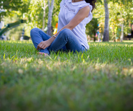 Teen girl siting on grass