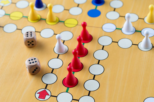 Playing ludo game with two dices. Closeup detail.