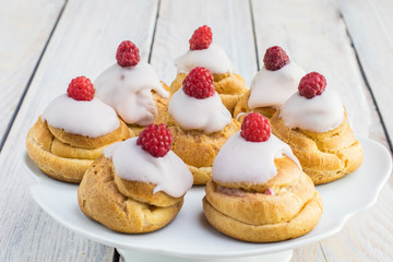 Raspberries Profiterole with White Chocolate on Plate