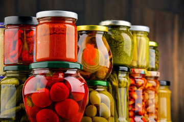 Jars with variety of pickled vegetables.
