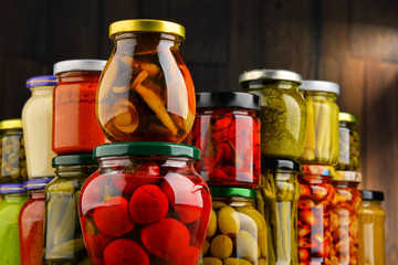 Jars with variety of pickled vegetables.