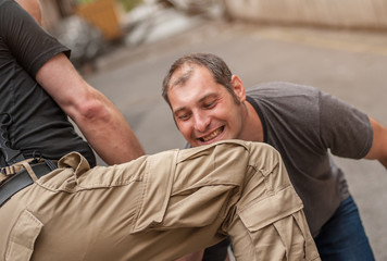 Obraz premium Kapap instructor demonstrates self defense techniques against a gun point. Gun Disarm.