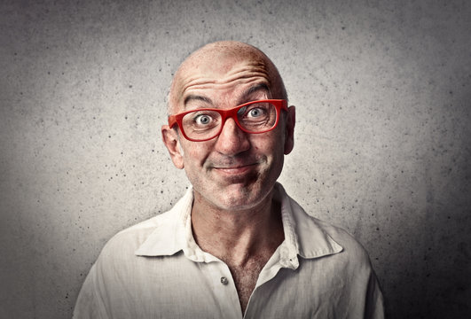 Smiling man wearing red glasses