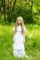 Portrait cute blonde girl outdoors in summer