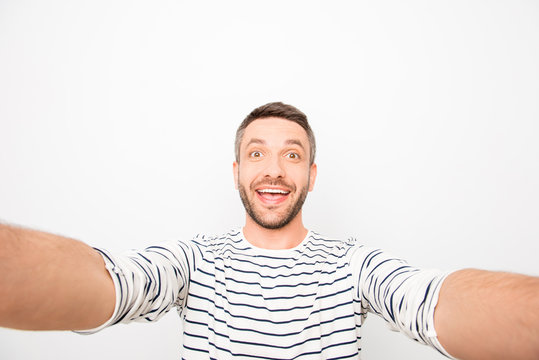 Happy cheerful handsome man making funny selfie