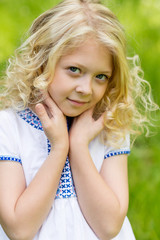 Fototapeta premium Portrait cute blonde girl outdoors in summer