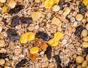 Close-up of dry muesli with nuts and raisins from above