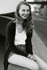 Fototapeta premium Young attractive girl sits outside