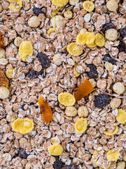 Close-up of dry muesli with nuts and raisins from above