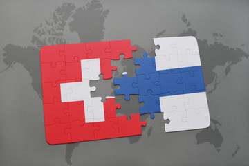 puzzle with the national flag of switzerland and finland on a world map background.