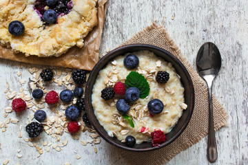 healthy homemade oatmeal with berries and berry cake for breakfast. top view