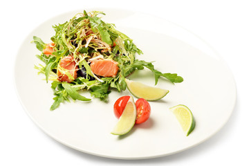 Salmon and ruccola fresh salad on plate isolated on white