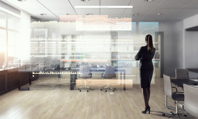 Businesswoman in modern office interior  . Mixed media