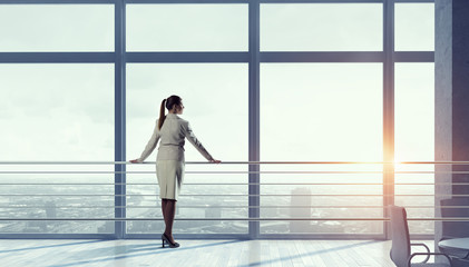 Obraz na płótnie Canvas Businesswoman in modern office interior . Mixed media