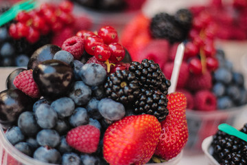 Fresh bowl of strawberry, raspberry, cranberry, blueberry and blackberry in old town prague's market.