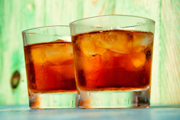 Glass of whiskey on a abstract wooden table