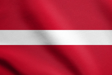 Flag of Latvia waving in wind with fabric texture