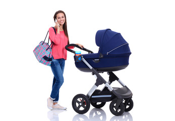 Full length portrait of a mother with a stroller talking on the phone, isolated on white background