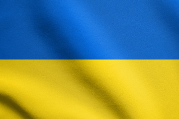 Flag of Ukraine waving in wind with fabric texture