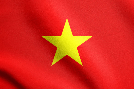 Flag of Vietnam waving in wind with fabric texture