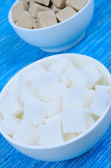 Sugar cubes in ceramic bowls