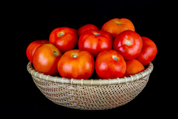 Tomatoes in a Rattan Bowl on a Black Background