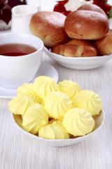 Tea party with meringue cookies and buns.