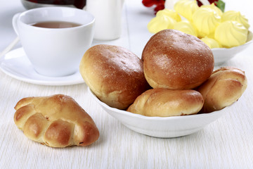 Tea party with buns and meringue cookies.