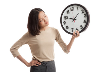 Young Asian business woman with a clock