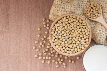 Glass with Soy Milk and beans on wooden background