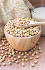 Glass with Soy Milk and beans on wooden background