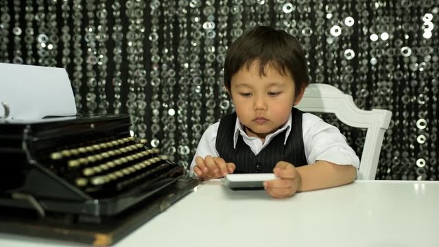 boy adds up numbers on a calculator