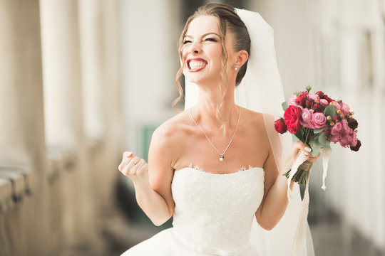 Luxury wedding bride, girl posing and smiling with bouquet