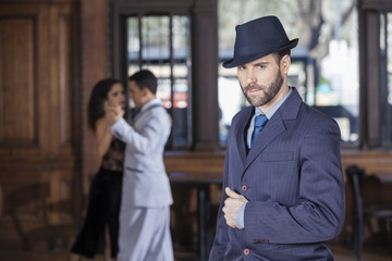 Confident Tango Dancer Standing While Partners Performing In Res