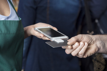 Saleswoman Accepting Payment From Customer In Pet Store