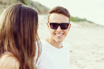 Romantic young couple sitting on the beach